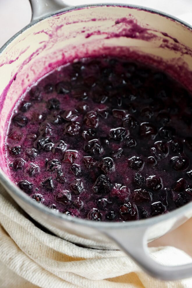 cooking blueberries in a saucepan with sugar and water